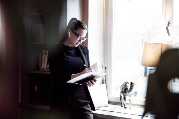 Legal professional reading documents beside a lamp